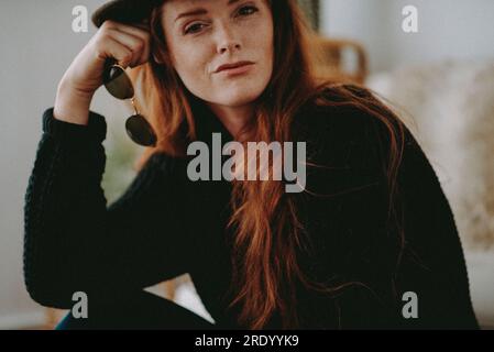 Redheaded Woman with Sunglasses and Hat Stock Photo
