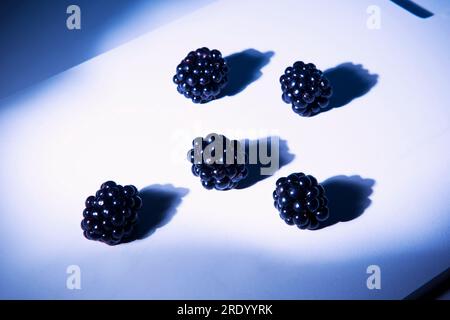 Blackberries lying on cutting board Stock Photo