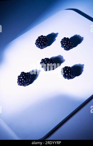 Blackberries lying on cutting board Stock Photo