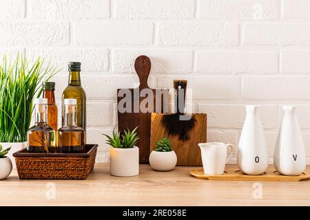Beautiful kitchen backdrop with storage area for various bottled oils. cutting boards. Indoor flowers in the inside of the kitchen. Compact storage Stock Photo