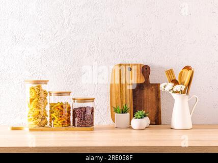 A set of white ceramic storage jars and wooden cutting boards in the  interior of an eco-friendly kitchen. minimalism. Eco items Stock Photo -  Alamy