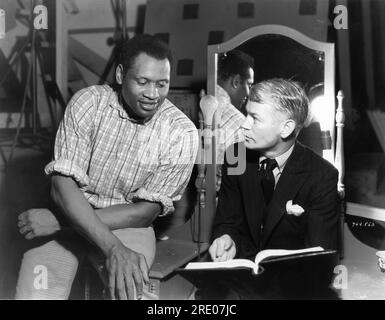 PAUL ROBESON and Director JAMES WHALE on set candid reading script during filming of SHOW BOAT 1936 director JAMES WHALE novel Edna Ferber music Jerome Kern lyrics Oscar Hammerstein II Universal Pictures Stock Photo