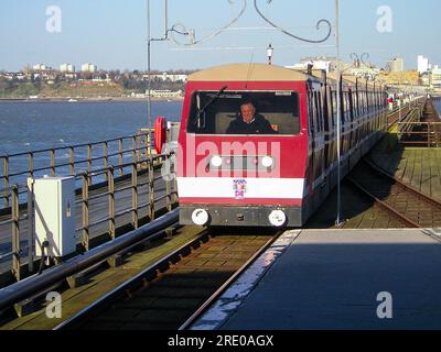 Old red scheme Southend Pier Railway diesel train approaching the station at the end of Southend Pier in Thames Estuary, Southend on Sea, Essex, UK. Stock Photo