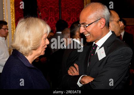 File photo dated 24/10/2013 of the Duchess of Cornwall talking to the British journalist and BBC news presenter, George Alagiah (right). George Alagiah has died aged 67 after being diagnosed with bowel cancer in 2014, his agent said. Issue date: Thursday October 24, 2013. Stock Photo