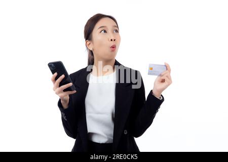 Portrait young asian business woman hold credit card and looking smart phone for shopping online isolated white background, businesswoman looking debi Stock Photo