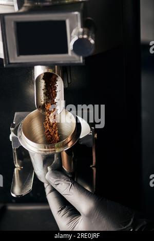 barista holding tamper near portafilter with grinded coffee, espresso, manual  press Stock Photo by LightFieldStudios