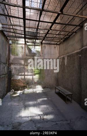 KGB Museum interior in The Corner House. Exercise yard where arrested Latvians could vent. Walkway above the fence for armed guards Stock Photo