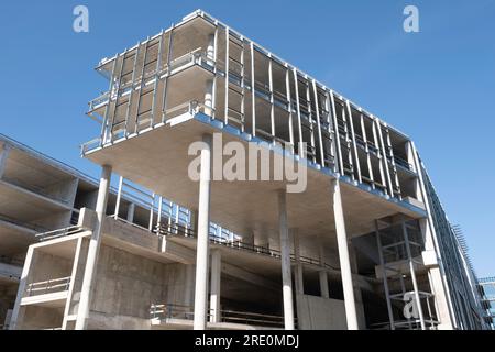 Construction site. Concrete posts and floors already indicate the shape of the building to be built Stock Photo