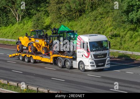 BRIT EUROPEAN Transporting commercial Sunbelt Rentals Stage 5 vehicles. JCB 535-95 construction Loadall plant machinery travelling on the M6 motorway in Greater Manchester, UK Stock Photo