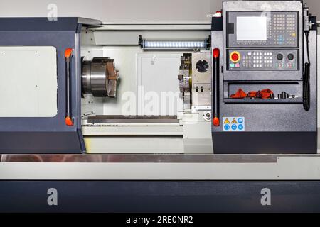 Industrial CNC lathe with six position turret and fast pneumatic 3-jaw chuck for gripping or clamping the workpiece. Close-up. Copy space. Stock Photo