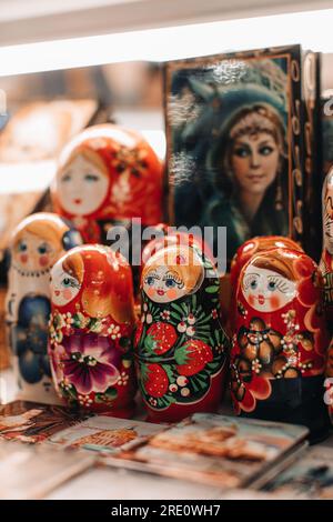 Hand painted famous Russia wooden doll Matryoshka. Females cartoon faces with red lipstick and rosy cheeks. Traditional souvenir. Vertical Stock Photo Alamy