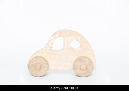 Small old wooden car on a white background close-up Stock Photo
