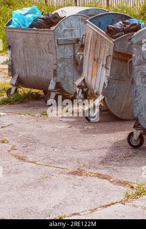 https://l450v.alamy.com/450v/2re122m/metallic-garbage-container-filled-with-plastic-waste-bags-on-the-street-selective-focus-2re122m.jpg