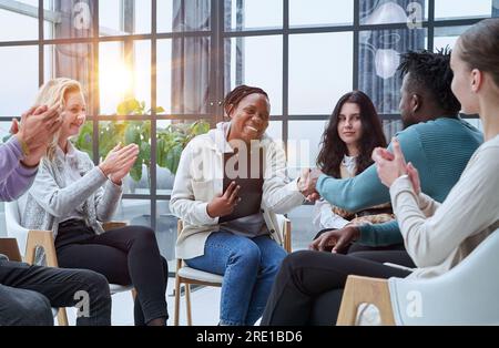Photo of partners clapping hands after business seminar. Stock Photo