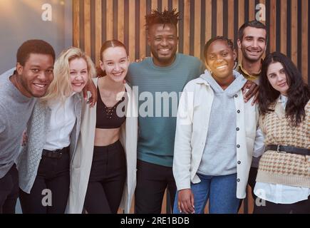 Happy diverse professional business team stand in office looking at camera, Stock Photo
