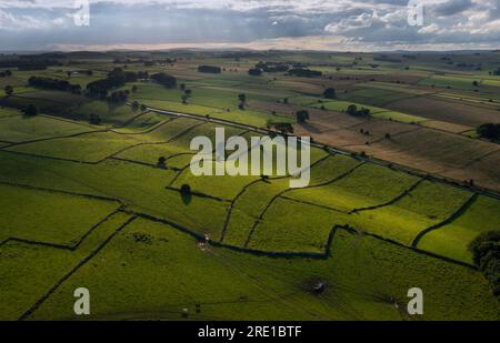 drone views over Derbyshire peak district landscape near Monyash showing dry stone wall field partitioning Stock Photo
