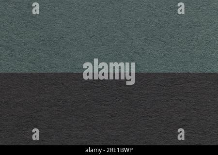 Texture of craft dark green and black paper background, half two colors, macro. Structure of vintage dense teal cardboard. Felt backdrop closeup. Stock Photo