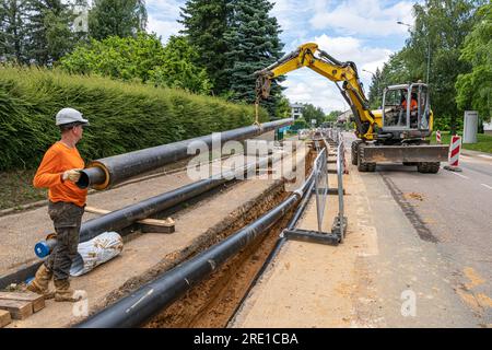 Bois Guillaume (Normandy, northern France): highway maintenance, district heating. Heating network expansion: laying underground pipes. Workers on the Stock Photo