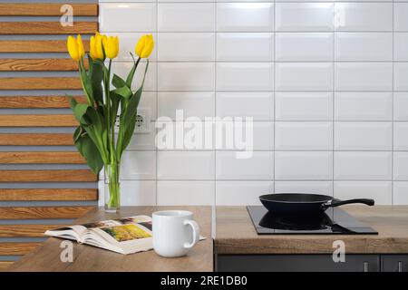 Frying pan on induction hob in the kitchen at home Stock Photo