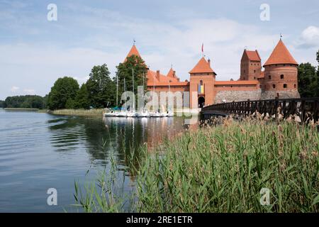 Old Trakai Castle and Museum with corner towers, Ducal Palace and wooden footbridge on the island in the middle of Lake Galve Stock Photo