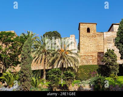 Medieval stone arches and walkway by the walls and towers of an ancient Alcazaba fortress in Malaga, Spain Stock Photo