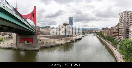 Bilbao Spain - 07 05 2021: Panoramic exterior view at the Bilbao downtown city, Nervion river and river banks, Salve Bridge, Guggenheim Museum Bilbao Stock Photo