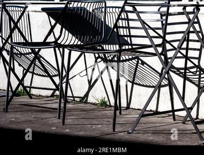 metal café chairs and their shadows Stock Photo