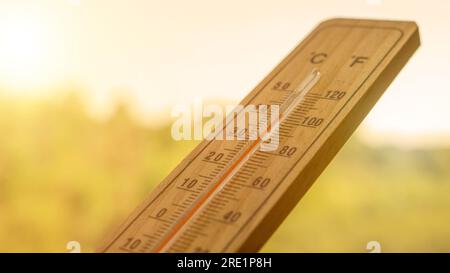 Heat waves and high-temperature concept.Wooden thermometer showing extreme temperatures during the summer season. Global warming concept Stock Photo