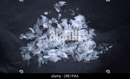 Macro shot on a pile of disintegrated micro plastic particles from plastic bottles and trash bags. Old decomposed and broken down plastic material Stock Photo
