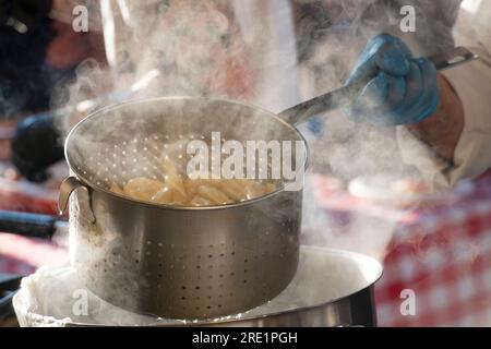 Italy, Street Food Festival, Cooking Pasta in Boiling Water Stock Photo