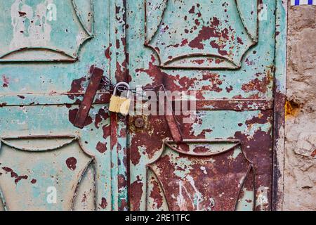 Rusty metallic door with a padlock Stock Photo