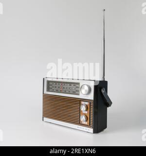 Authentic radio from the 70s. Front right view. Isolated on white background. Traces of time and scuffs on the case Stock Photo