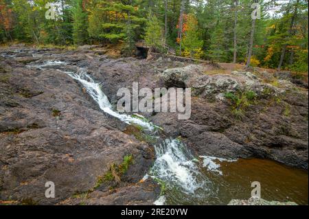 The various river features of the Amnicon River as it flows through Amnicon Falls State Park in Wisconsin. Stock Photo