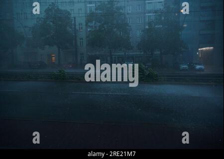 Berlin, Germany. 24th July, 2023. Heavy rain and wind come down on Prenzlauer Allee in the evening. Credit: Annette Riedl/dpa/Alamy Live News Stock Photo