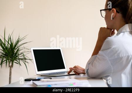Woman working on laptop calling video using her laptop, networking, web conference. Stock Photo