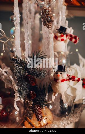 Christmas toy figurine of funny Snowman. Christmas magic composition. New Year festive details Stock Photo