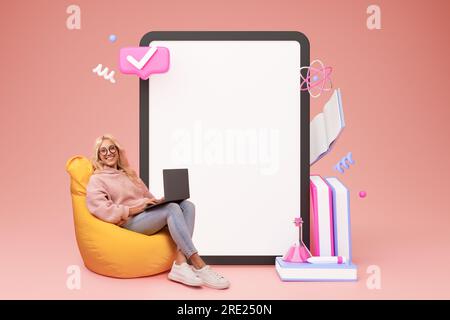 Lady Using Laptop Near Big Digital Tablet On Pink Background Stock Photo