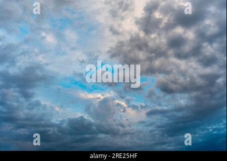 Incredibly beautiful clouds with a blue gap. Evening sky after the rain. Stock Photo