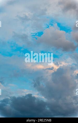 Incredibly beautiful clouds with a blue gap. Evening sky after the rain. Stock Photo