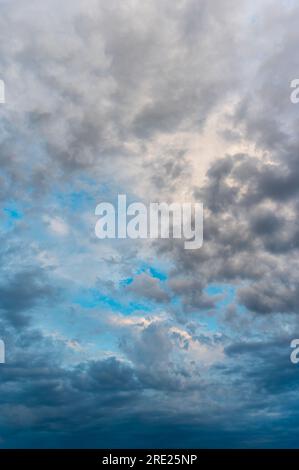 Incredibly beautiful clouds with a blue gap. Evening sky after the rain. Stock Photo