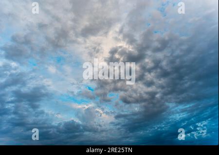 Incredibly beautiful clouds with a blue gap. Evening sky after the rain. Stock Photo