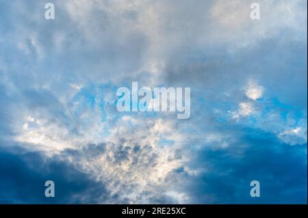 Incredibly beautiful clouds with a blue gap. Evening sky after the rain. Stock Photo