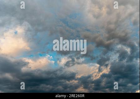 Incredibly beautiful clouds with a blue gap. Evening sky after the rain. Stock Photo