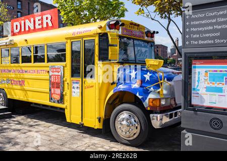 Liverpool, united kingdom May, 16, 2023 An American style yellow school bus is used as a diner restaurant at the popular Royal Albert Dock tourist att Stock Photo