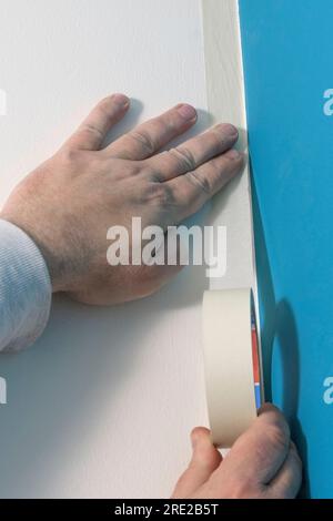 Close-up of sticking tape on the ceiling before painting the wall Stock Photo