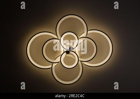 Luminous modern LED ring lamp on the ceiling. Bottom view. Stock Photo