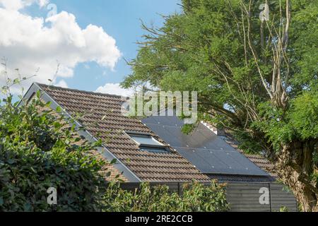 Solar panels on the roof of a one-story house with a corner roof Stock Photo