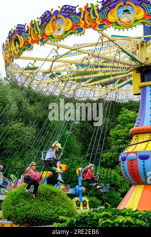 Kazakhstan, Almaty. People on Amusement Park Ride, Central Park for Culture and Recreation. Stock Photo