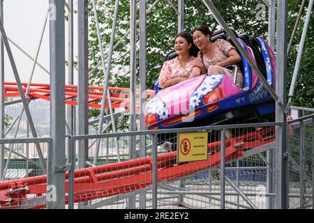 Kazakhstan Almaty. Passengers on Roller Coaster at Kok Tobe