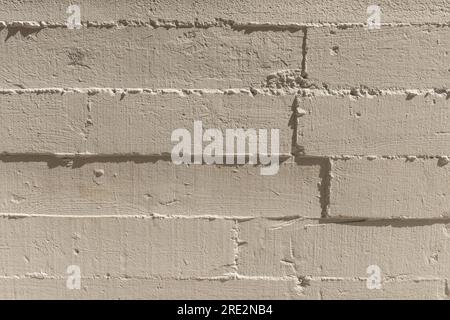 A white painted concrete wall with grain marks from the wooden formwork Stock Photo